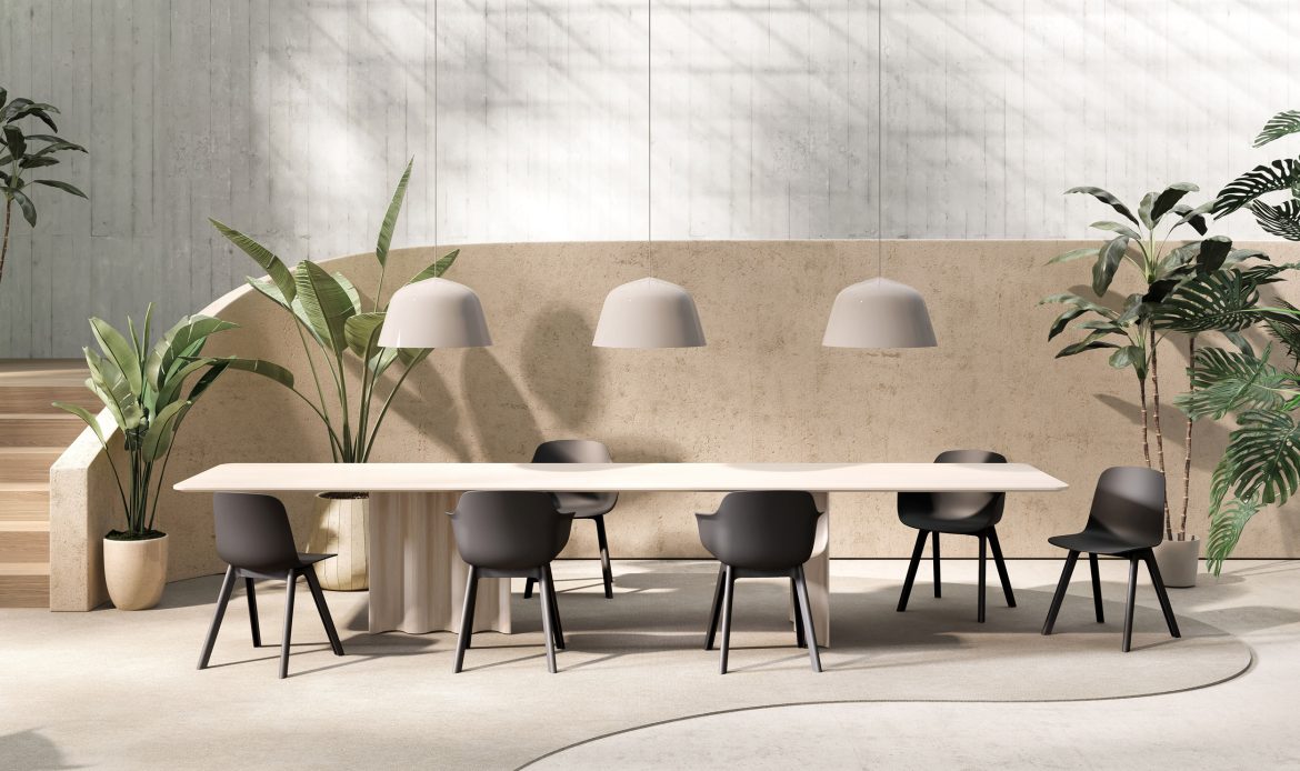 A modern dining room with a rectangular light wood table, black polypropylene chairs from Colos' Loria collection and hanging lamps, surrounded by green plants and concrete walls.